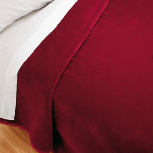 Premium soft velvet blanket in garnet on a bed (220×240 cm)