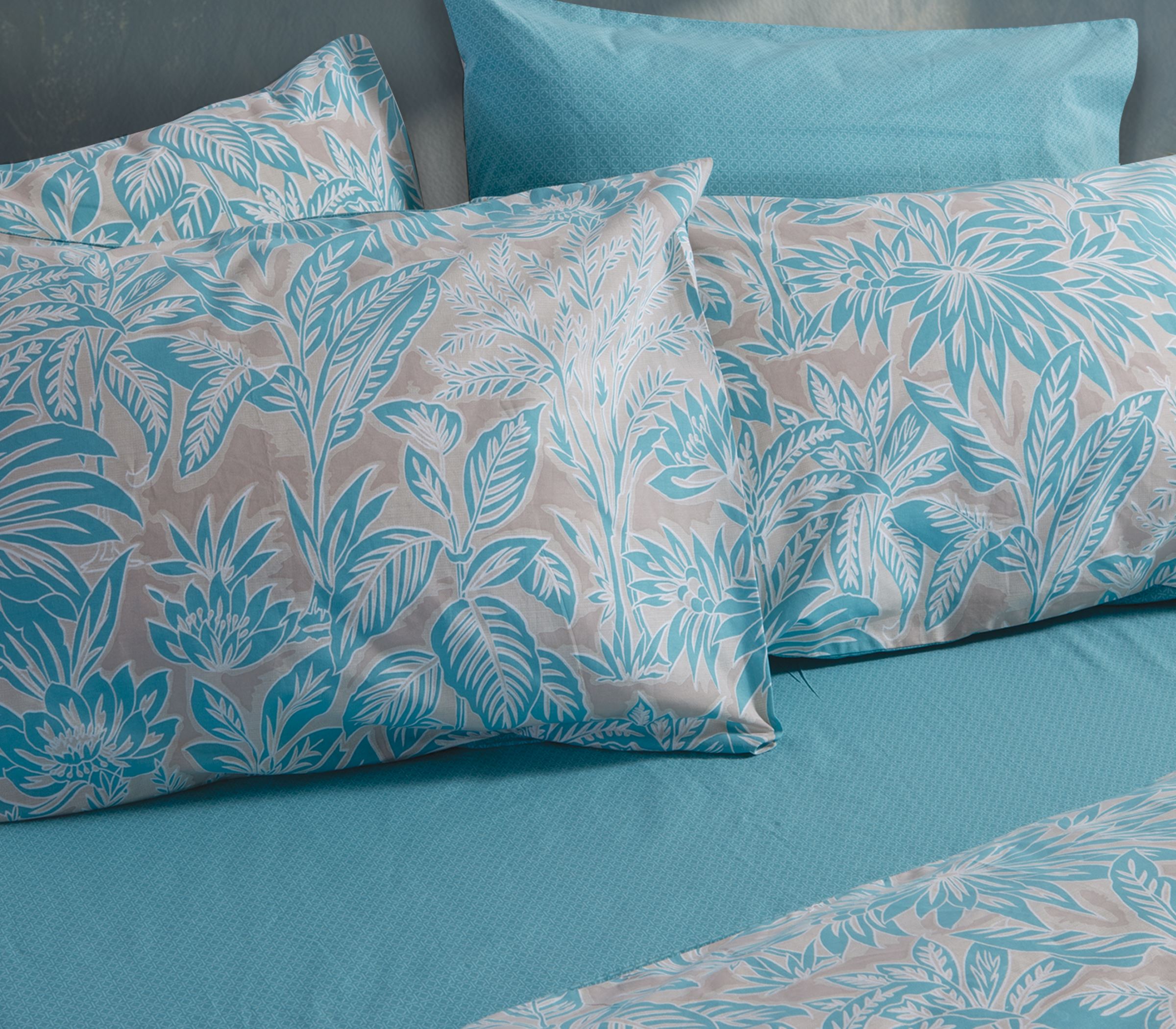 Queen size fitted bedsheet set in Charisma Blue color, made from soft cotton fabric with a smooth finish, featuring a solid blue design for a modern bedroom look.