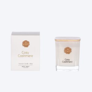 Scented candle with orange blossom, pink pepper, clove, berries, and vanilla fragrance notes.