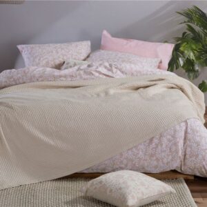 Beige 100% cotton pique blanket with a textured waffle weave, folded to showcase its soft garment-washed finish and lightweight design.