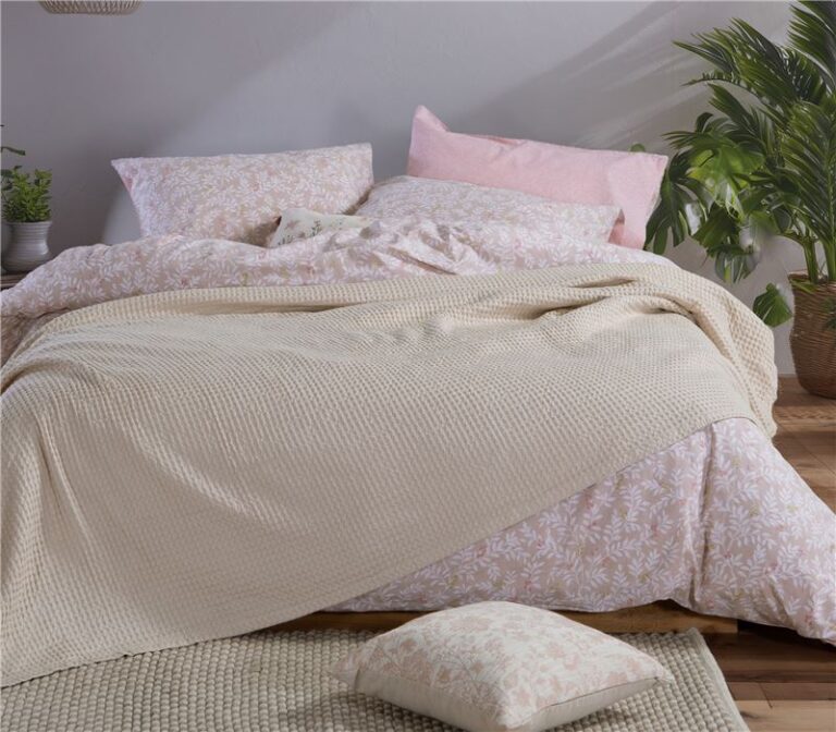 Beige 100% cotton pique blanket with a textured waffle weave, folded to showcase its soft garment-washed finish and lightweight design.
