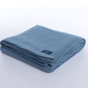 Nau Navy cotton piqué blanket with a textured woven design in a classic navy shade.