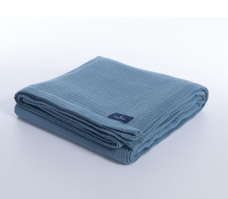 Nau Navy cotton piqué blanket with a textured woven design in a classic navy shade.