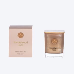 Scented candle with citrus, rose, cedar, sandalwood, and vanilla fragrance notes.