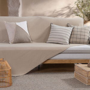 Beige woven sofa throw with a textured pattern, neatly folded to showcase its soft fabric and decorative finish.